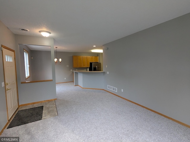 18061 96th Ave N, Maple Grove, MN 55311 - unfurnished living room with a chandelier, light carpet, and baseboards