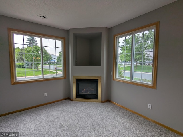 18061 96th Ave N, Maple Grove, MN 55311 - unfurnished living room featuring carpet floors, baseboards, and a glass covered fireplace