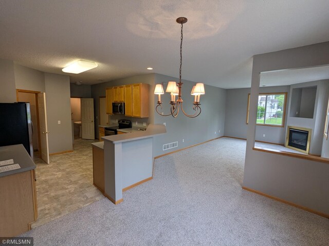 18061 96th Ave N, Maple Grove, MN 55311 - kitchen featuring stainless steel appliances, a glass covered fireplace, baseboards, light countertops, and a chandelier