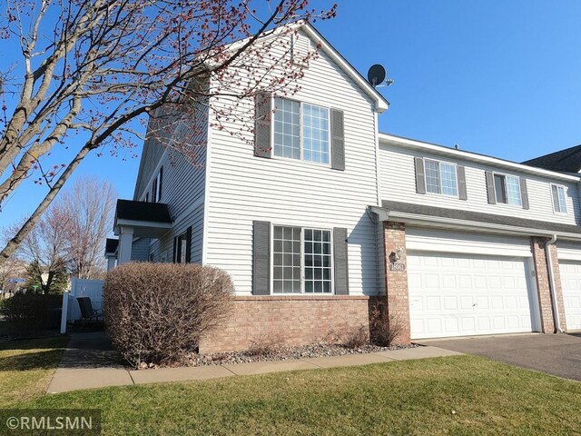 18061 96th Ave N, Maple Grove, MN 55311 - view of front of home featuring a garage, asphalt driveway, and brick siding