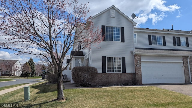 18061 96th Ave N, Maple Grove, MN 55311 - traditional-style home with driveway, brick siding, a front yard, and a garage