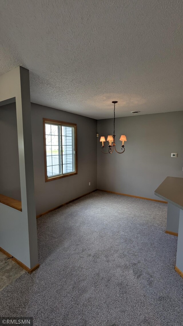 18061 96th Ave N, Maple Grove, MN 55311 - unfurnished dining area featuring carpet floors, a chandelier, a textured ceiling, and baseboards