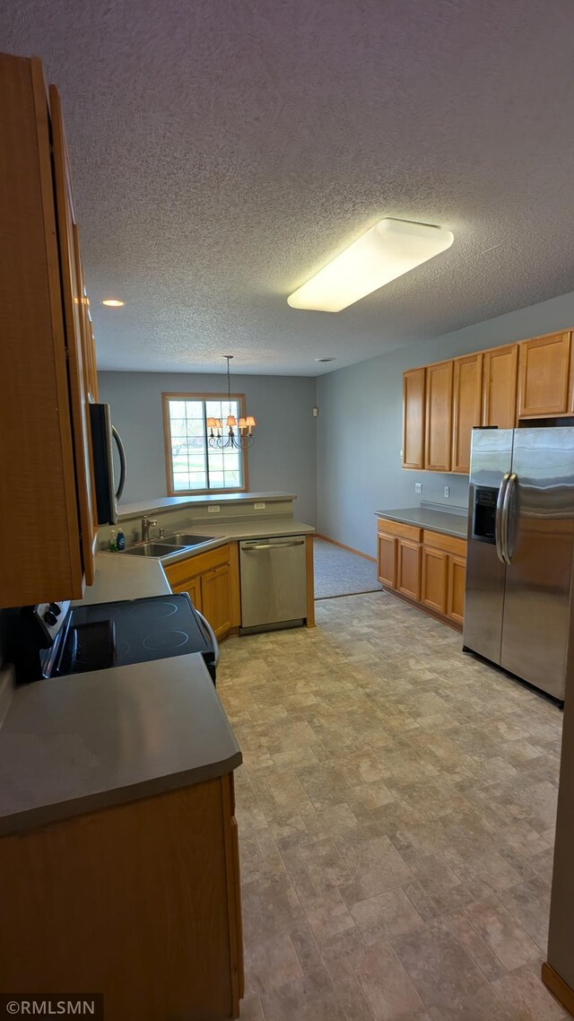 18061 96th Ave N, Maple Grove, MN 55311 - kitchen featuring appliances with stainless steel finishes, a textured ceiling, a chandelier, a sink, and pendant lighting