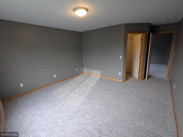 18061 96th Ave N, Maple Grove, MN 55311 - spare room featuring carpet flooring, baseboards, and a textured ceiling