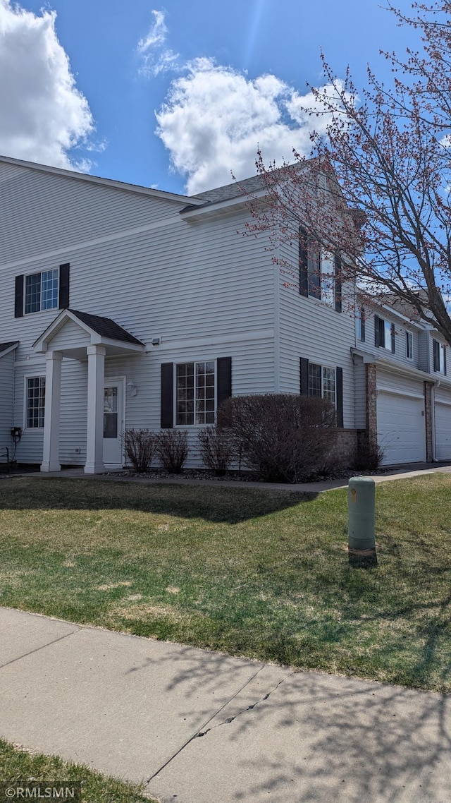 18061 96th Ave N, Maple Grove, MN 55311 - view of front of house featuring a front lawn and an attached garage