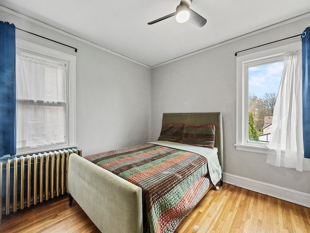 580 Snelling Ave S Unit 4, Saint Paul, MN 55116 - bedroom featuring baseboards, radiator, ornamental molding, and wood finished floors