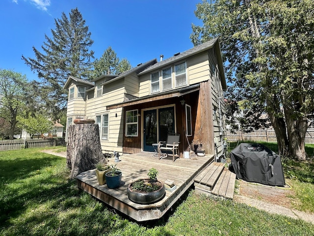 rear view of property featuring a deck