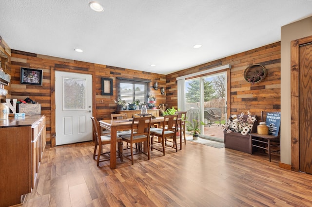 12 Oak Ave SE, Racine, MN 55967 - dining room featuring light wood finished floors, wooden walls, recessed lighting, and a textured ceiling