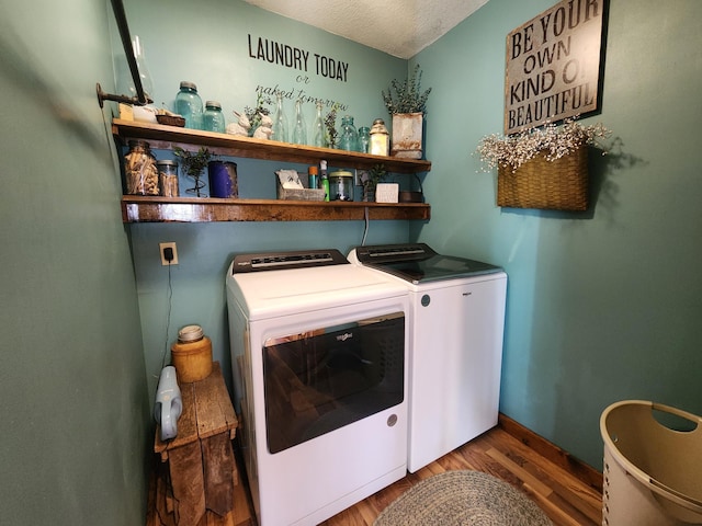 12 Oak Ave SE, Racine, MN 55967 - washroom featuring washing machine and clothes dryer, wood finished floors, a textured ceiling, and baseboards
