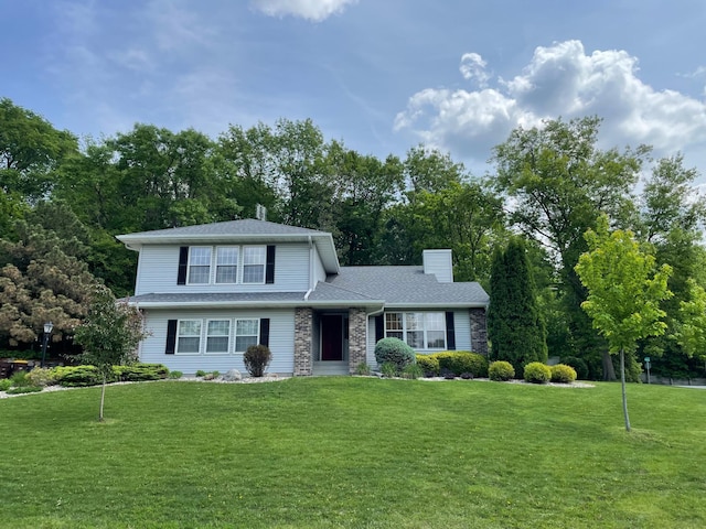 801 Eclipse Pkwy, New Prague, MN 56071 - view of front facade with a chimney, a front yard, and stone siding