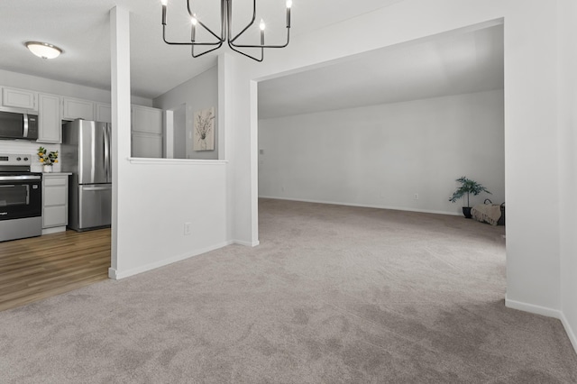 6970 Langford Ct, Edina, MN 55436 - unfurnished dining area with carpet floors, a chandelier, and baseboards