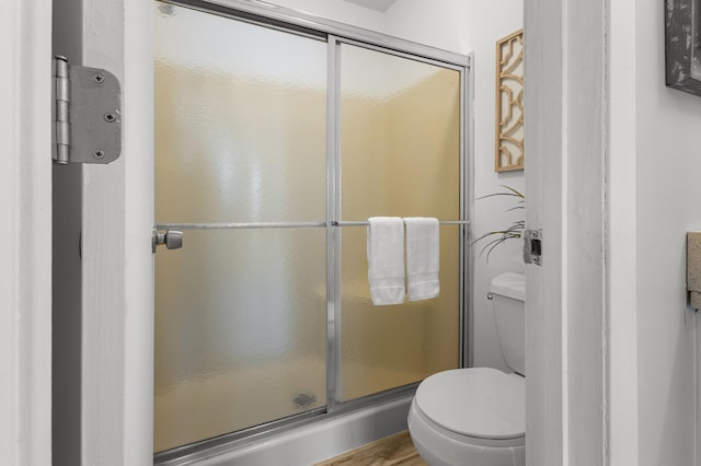 6970 Langford Ct, Edina, MN 55436 - bathroom with toilet, a stall shower, and wood finished floors