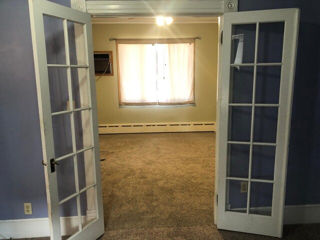 unfurnished room with carpet flooring and a baseboard radiator
