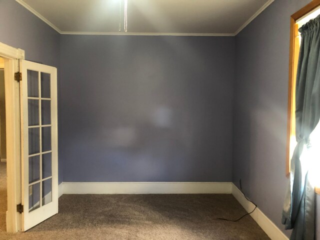 spare room with baseboards, carpet flooring, and ornamental molding