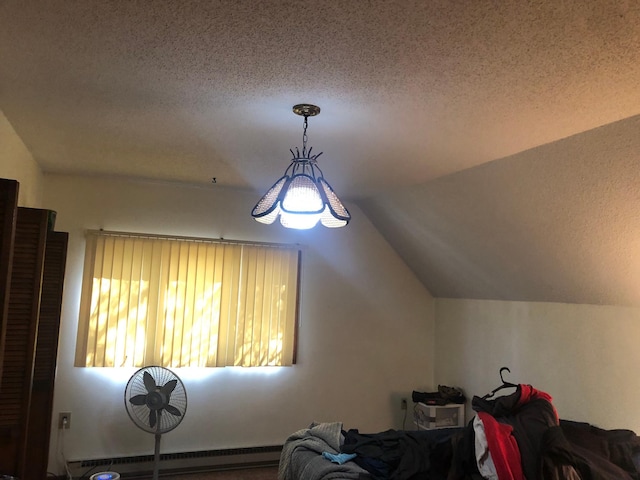 interior space featuring baseboard heating, lofted ceiling, and a textured ceiling