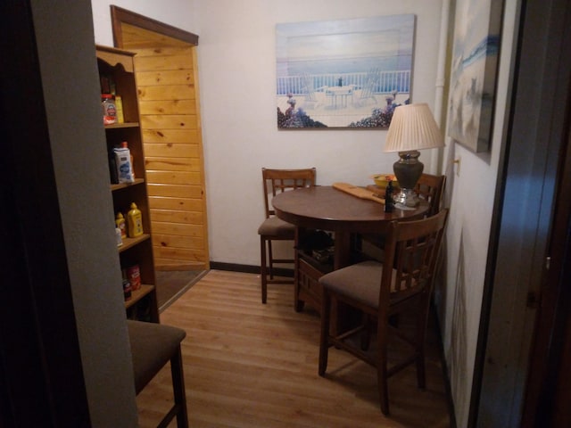 dining space featuring baseboards and wood finished floors