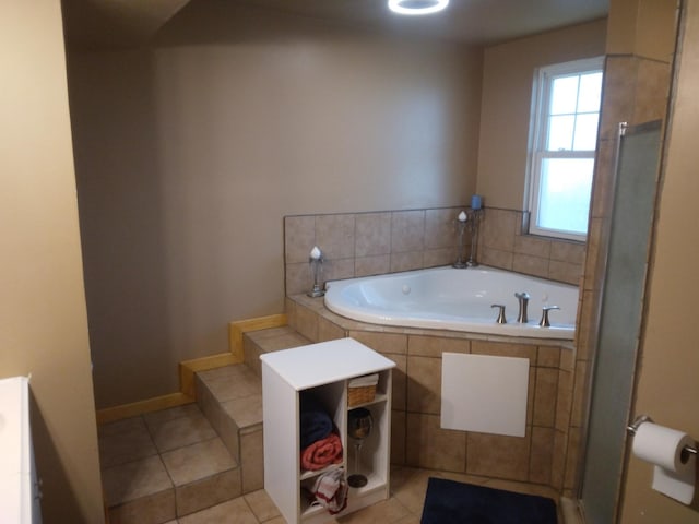 full bath with a garden tub, baseboards, and tile patterned floors