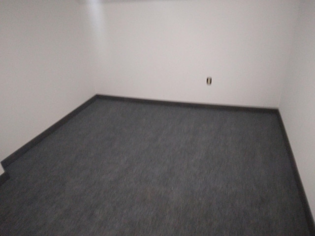 empty room with baseboards and carpet flooring