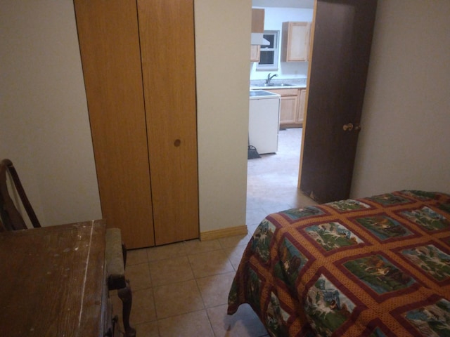 bedroom featuring a sink and light tile patterned floors