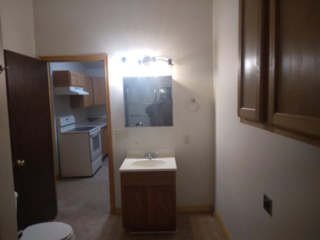 half bath with vanity, baseboards, tile patterned flooring, and toilet