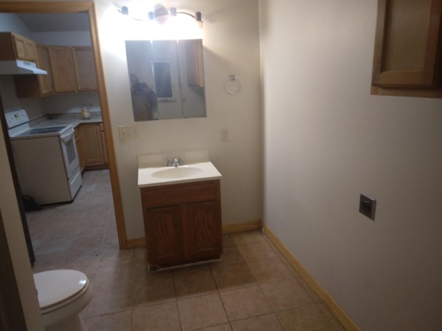 bathroom featuring toilet, baseboards, tile patterned flooring, and vanity