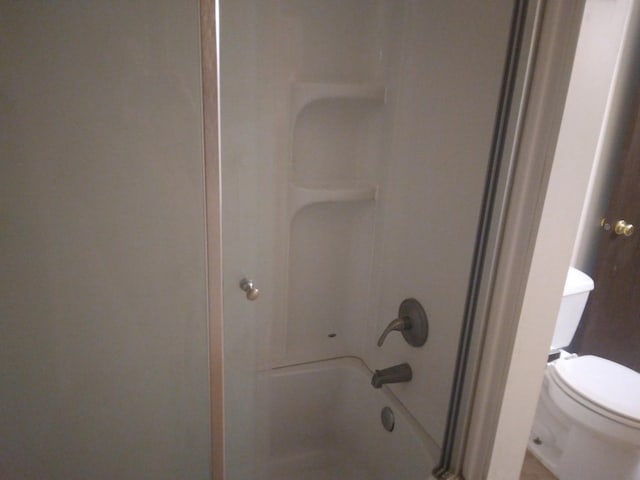 full bath with a tub to relax in, walk in shower, and toilet