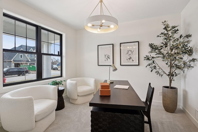 carpeted office featuring a chandelier and baseboards