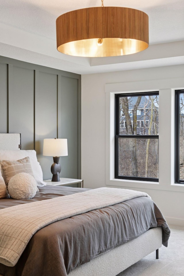 bedroom with carpet floors and multiple windows