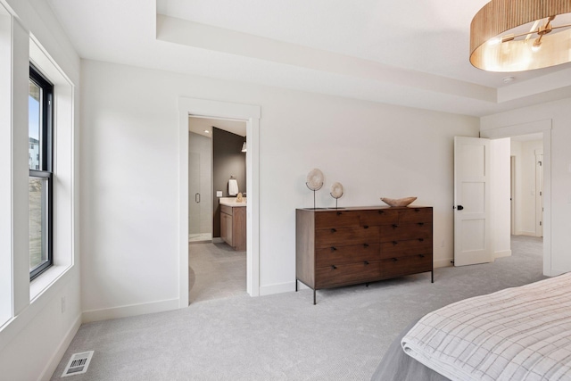 bedroom featuring visible vents, light colored carpet, and multiple windows