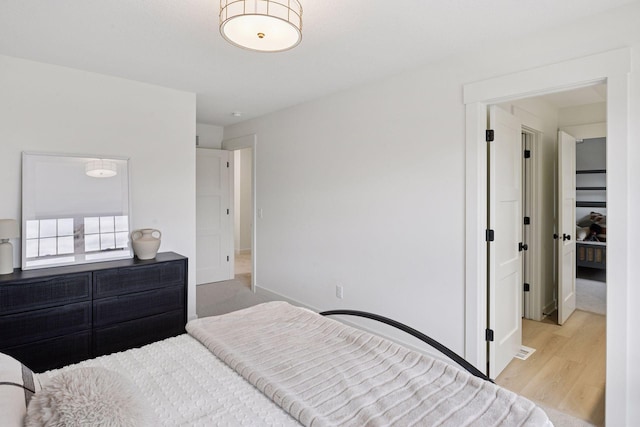 bedroom with wood finished floors and baseboards