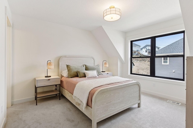 bedroom with light carpet, baseboards, and visible vents
