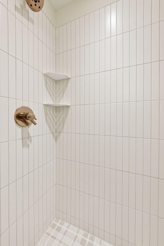 full bath with a tile shower