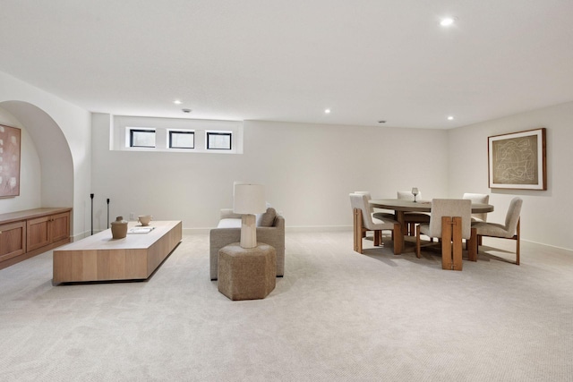 living area with baseboards, recessed lighting, and light colored carpet