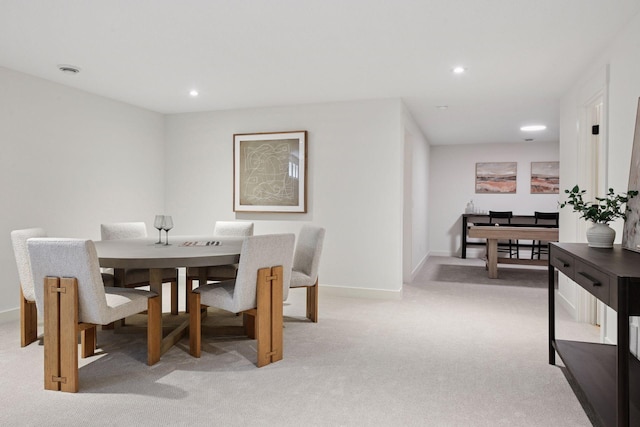 dining space featuring light carpet, baseboards, and recessed lighting