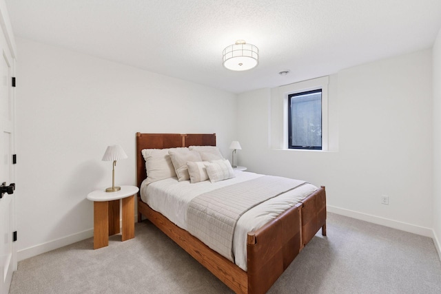 bedroom with baseboards and light colored carpet
