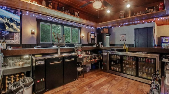 bar featuring wood ceiling, ceiling fan, and wood finished floors