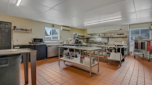 kitchen featuring a wall mounted air conditioner, stainless steel microwave, light tile patterned flooring, and open shelves