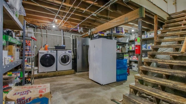 unfinished basement featuring freestanding refrigerator and independent washer and dryer