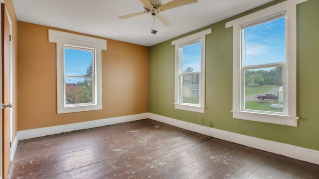 empty room featuring baseboards and hardwood / wood-style floors