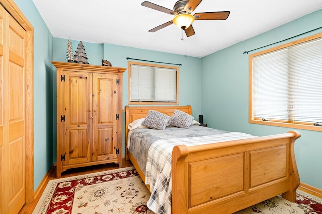 bedroom featuring ceiling fan, baseboards, and light wood-type flooring