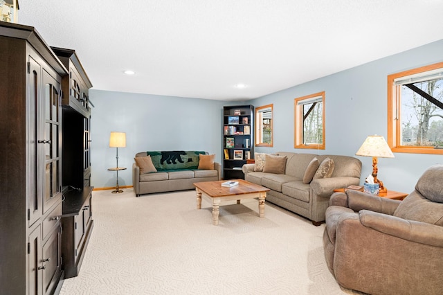 living area with light carpet, baseboards, and recessed lighting