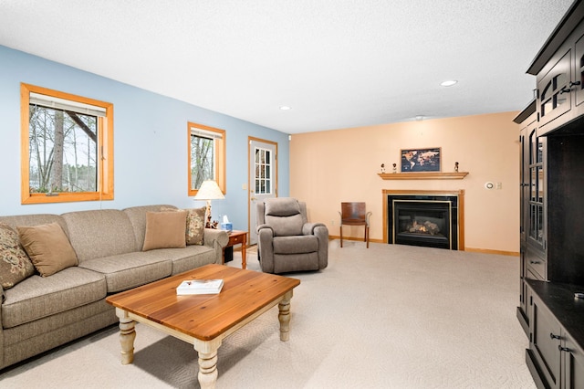 living area featuring a tile fireplace, carpet floors, baseboards, and recessed lighting