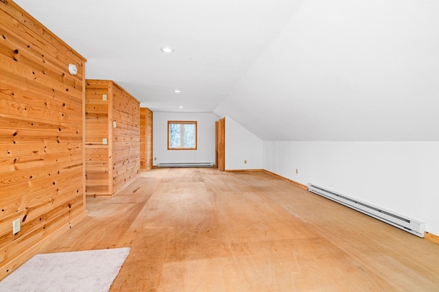 bonus room with baseboards, lofted ceiling, and a baseboard heating unit