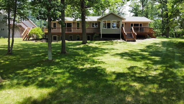 33853 Sand Rd, Sturgeon Lake, MN 55783 - rear view of house with stairs, a deck, and a lawn