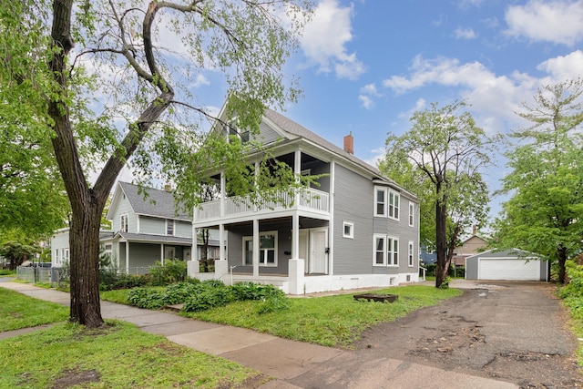2807 17th Ave S, Minneapolis, MN 55407 - view of front of house featuring a balcony, a garage, a front lawn, a chimney, and an outdoor structure