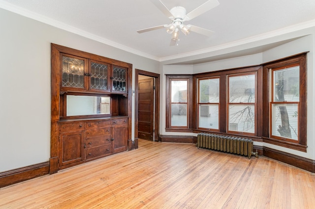 2807 17th Ave S, Minneapolis, MN 55407 - unfurnished room featuring radiator heating unit, light wood-type flooring, ornamental molding, ceiling fan, and baseboards