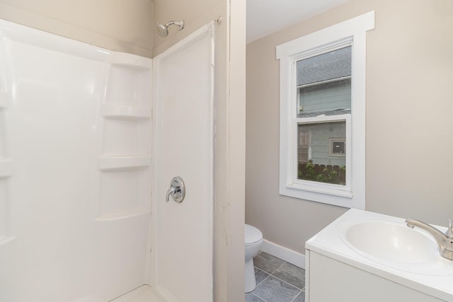 2807 17th Ave S, Minneapolis, MN 55407 - bathroom with a shower, baseboards, toilet, and vanity