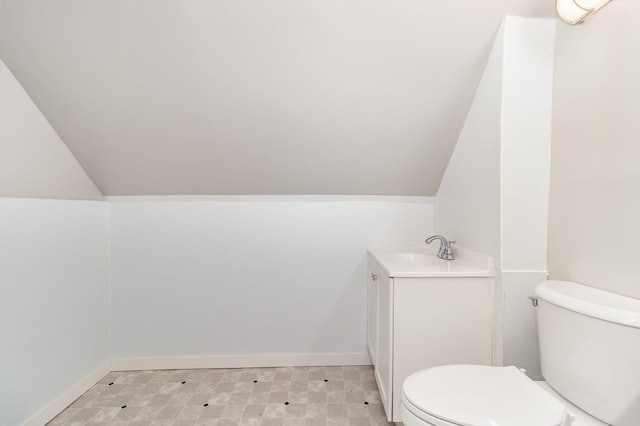 2807 17th Ave S, Minneapolis, MN 55407 - bathroom with toilet, vanity, lofted ceiling, and baseboards