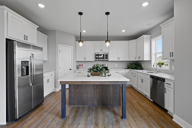 kitchen with white cabinets, appliances with stainless steel finishes, and light countertops