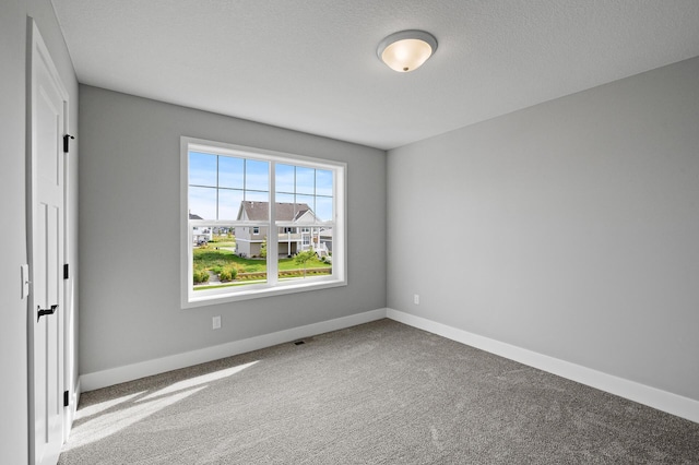 empty room with baseboards and carpet